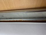 a close up of a metal door handle on a wooden door