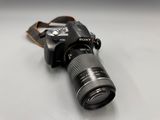 a camera that is sitting on a table with a strap around it