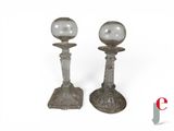 pair of silver candlesticks with glass globes on top