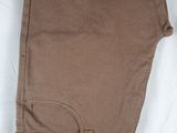 a close up of a pair of brown pants on a white surface