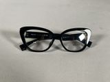 black and white cat eye glasses on a white surface
