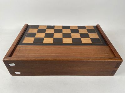 a wooden chess board with black and white squares on it