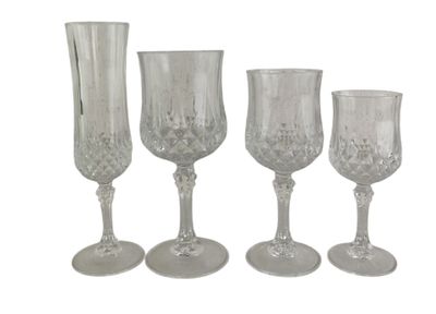 three clear glass goblets and a vase sitting next to each other