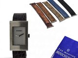 a picture of a watch, a book, and a book on a table