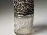 a glass jar with a silver lid sitting on a table