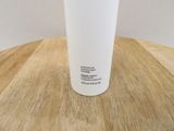a white cup sitting on top of a wooden table