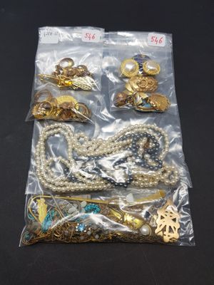 a close up of a bag of assorted jewelry on a table