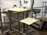 a table and stools in a room with a lot of clutter