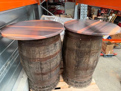 two wooden barrels sitting next to each other on a pallet
