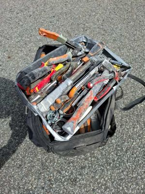 a suitcase full of tools sitting on the ground