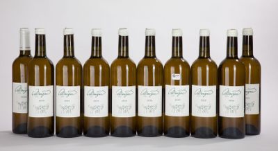 six bottles of wine are lined up in a row on a white surface