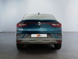 the rear end of a blue car in a white room