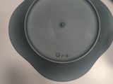 a blue bowl with a lid on a white table