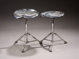 pair of silver stools with a marbled top and chrome legs