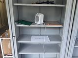 a white cabinet with shelves and a phone in it