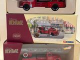 three boxed toy fire trucks in boxes on a white surface