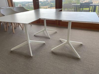 two tables that are sitting in the middle of a room