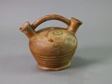 a small brown vase with a handle on a table