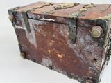 an old wooden chest with a metal latch on it