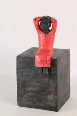 statue of a woman sitting on a block with her hands behind her head