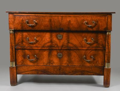 an antique chest of drawers with brass handles and a wooden top