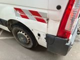 a white van with red stripes parked in a parking lot