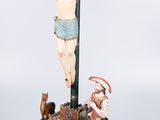 a figurine of jesus on the cross with a cat