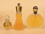 two bottles of perfume sitting next to each other on a white surface