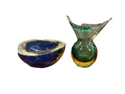 two glass vases sitting next to each other on a white surface