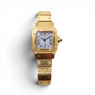 an image of a gold wrist watch with roman numerals and roman numerals