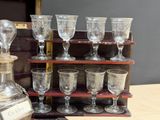many glasses and a decanter sitting on a table