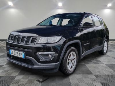 a black jeep compass suv parked in a garage
