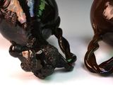 two vases that are sitting next to each other on a table