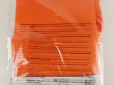 a close up of an orange sheet of paper on a white surface