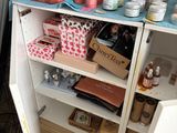 a small cabinet with a lot of beauty products on it