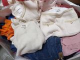 a bag full of clothes sitting on the floor