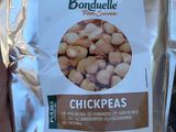 a bag of chickpeas in the hand of a person