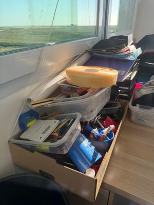 a desk with a drawer full of items on it