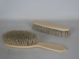 two brushes that are sitting on a table