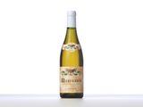 a bottle of white wine sitting on top of a table