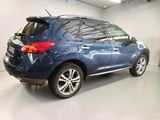 a picture of a blue car parked in a garage