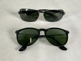 two pairs of ray bans with green lenses on a white surface