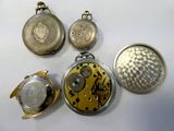 several different types of pocket watches are displayed on a white surface
