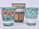 three cups sitting next to each other on a white surface