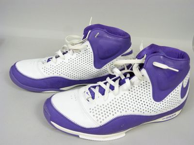 purple and white basketball shoes with white laces on a gray surface
