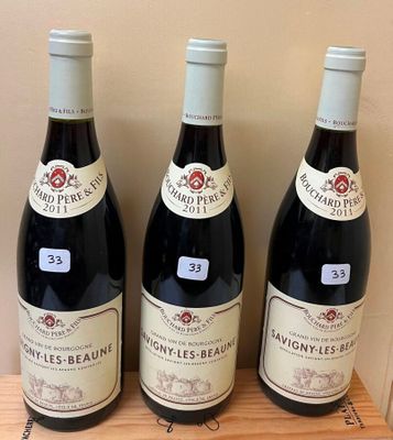 three bottles of wine sitting on a wooden shelf in front of a wall