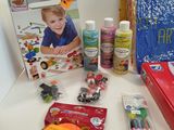 a table with craft supplies on it and a picture of a child