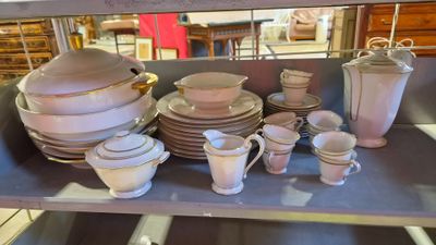 many plates and cups on a shelf in a store