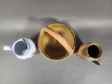 two cups and a bowl sitting on a table