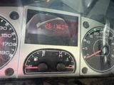 a close up of a car dashboard with a clock on it